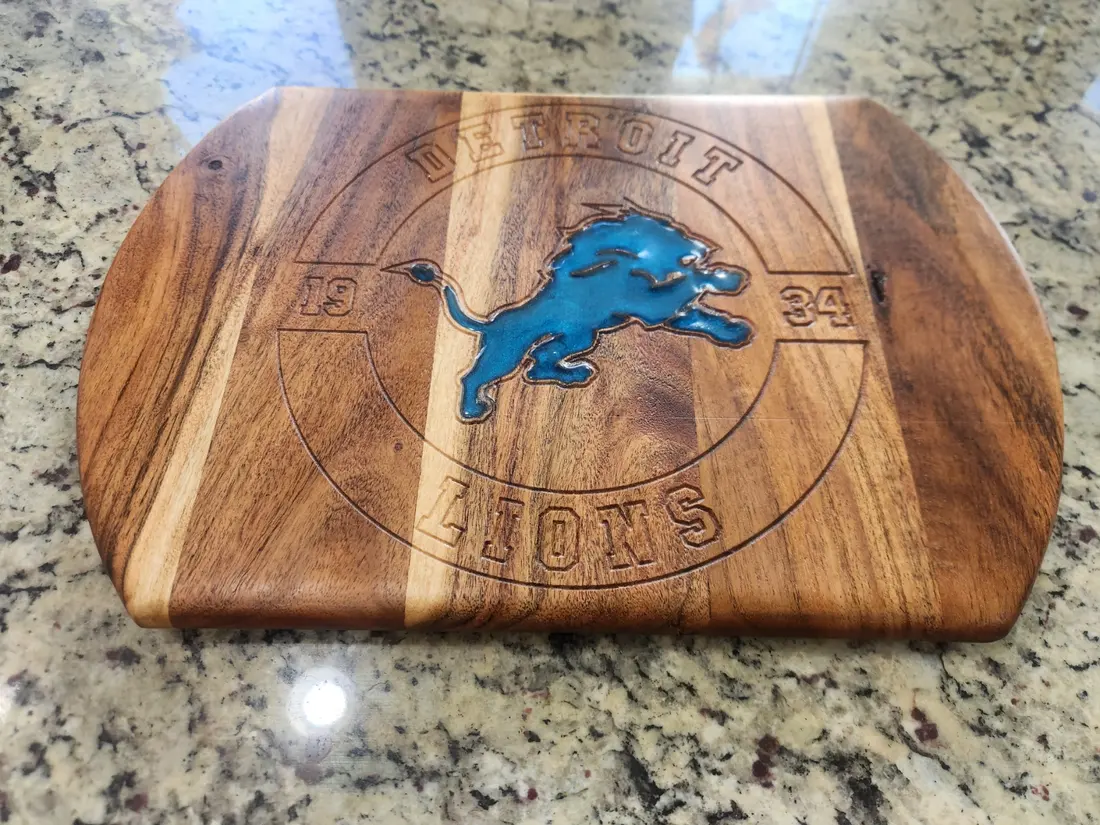 Wood cutting board engraved with a team logo