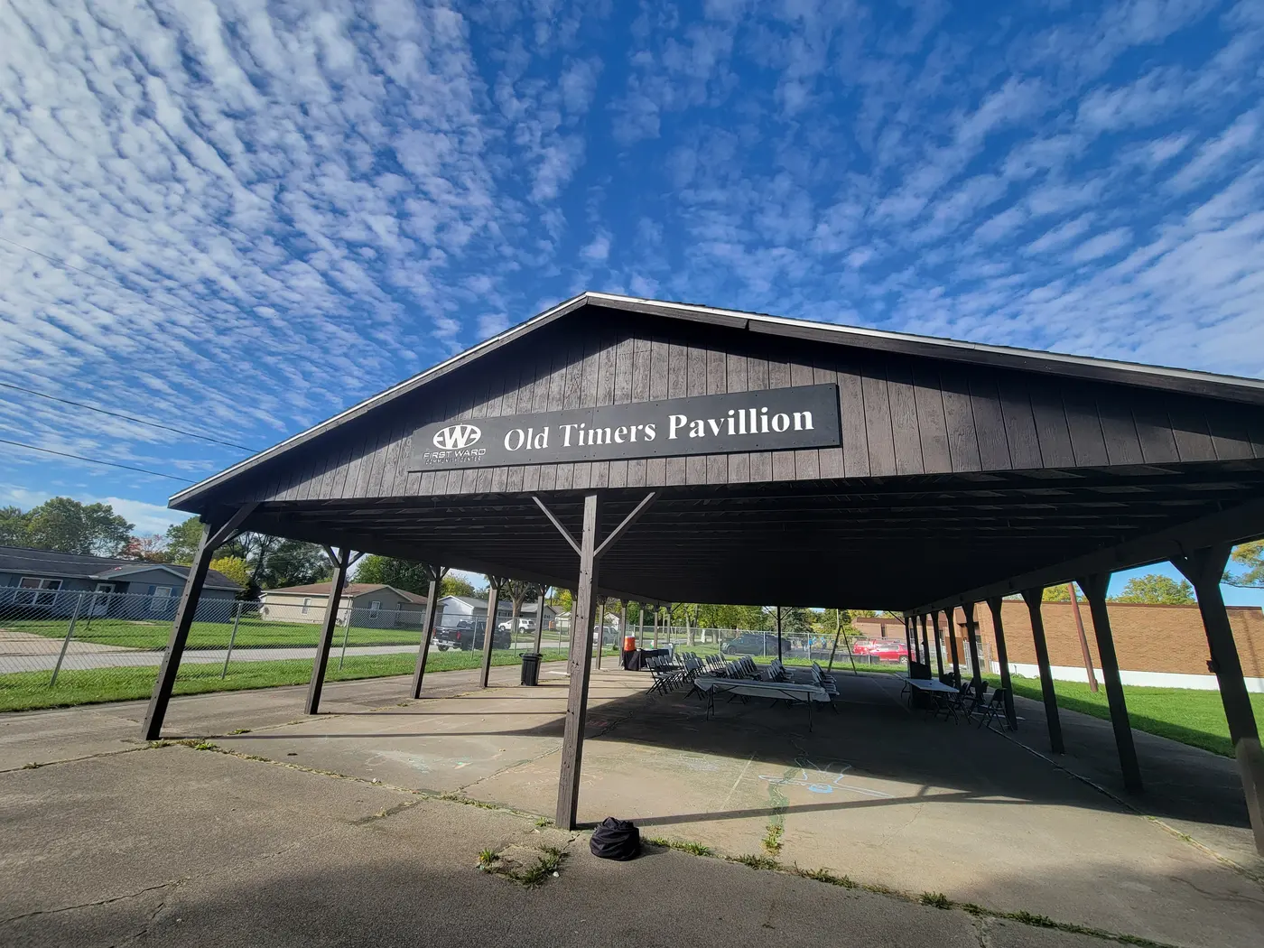The Old Timers Pavilion sign, installed under a blue sky